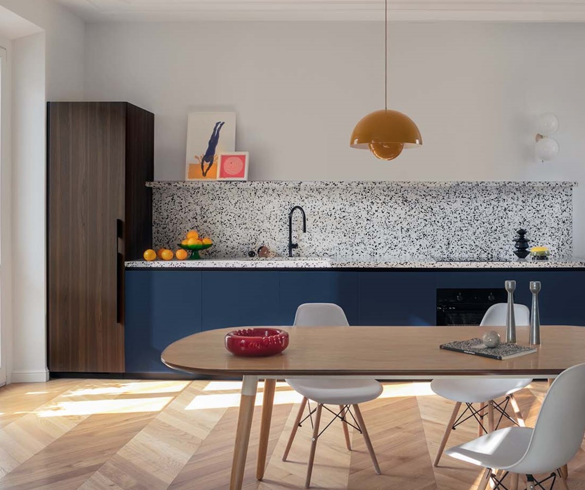 A kitchen with hanging pendant light and terrazzo backsplash