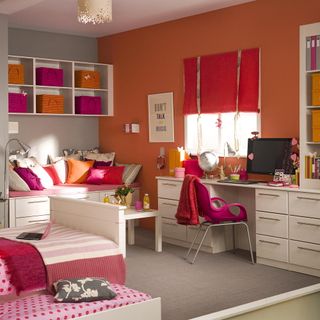 bedroom with light orange walls and white furniture