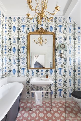 bathroom chandelier ideas brass ornate chandelier blue bathroom with printed wallpaper by HAM Interiors