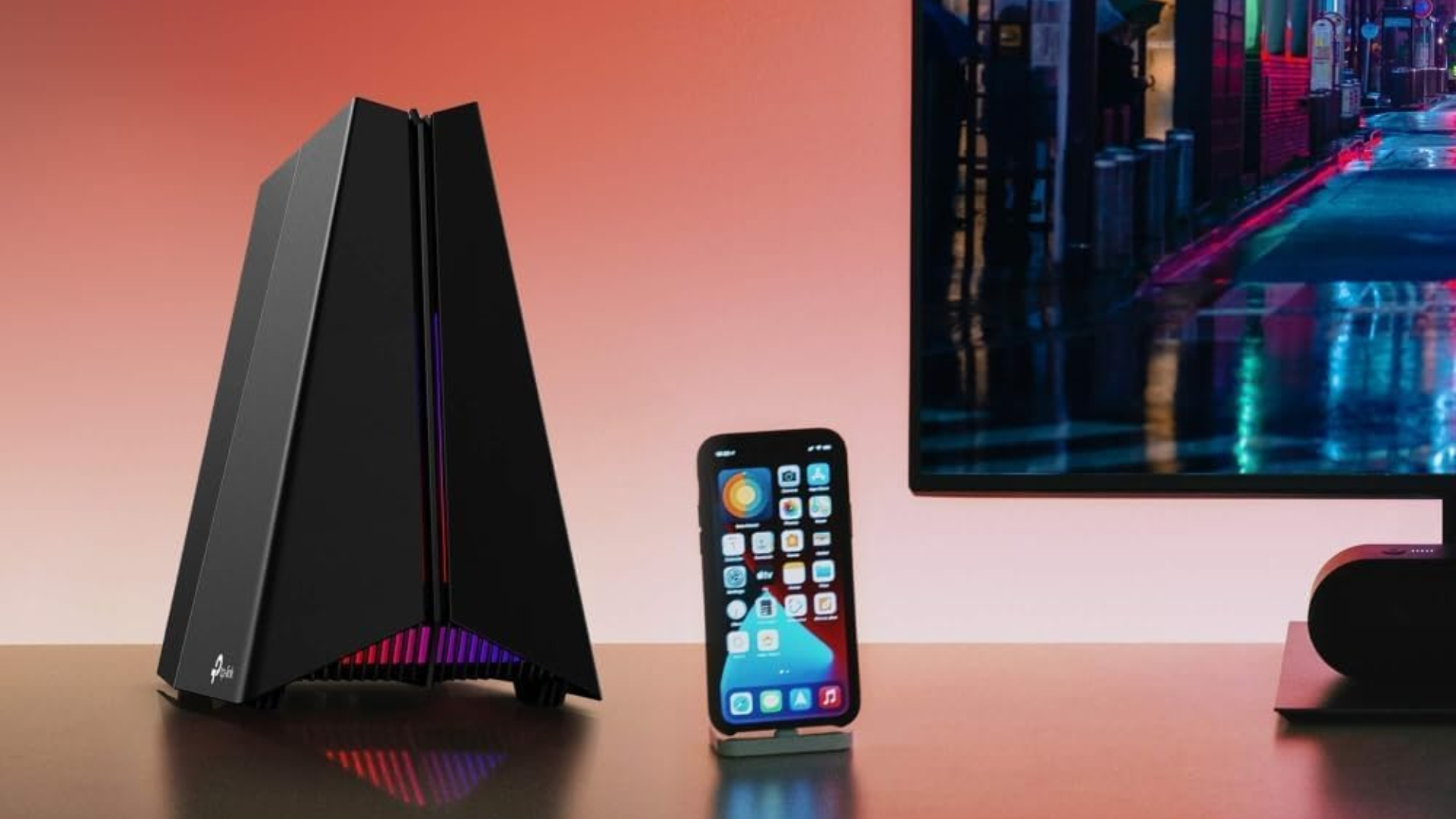 A TP-Link Wi-Fi 7 router on a desk next to a phone and monitor