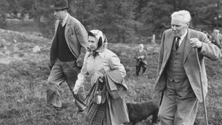 Queen of Great Britain Elizabeth II attends the North of Scotland Gun Dog Association's Open Stake Retriever Trials at Balmoral with one of the Trial judges Lord Porchester and one of the head gamekeepers James Gillan. (Photo by Cowper/Central Press/Getty Images)