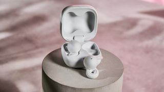 Sony LinkBuds Open with one bud outside of the charging case, and the other within it