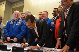 Los Angeles mayor Antonio Villaraigosa signs the title transfer for space shuttle Endeavour during a ceremony at the California Science Museum on Oct. 11, 2011. Endeavour will be permanently displayed at the science center for the public to see after delivery in 2012.