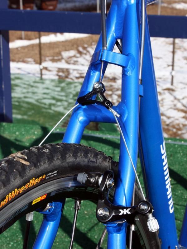 The barrel adjuster integrated into the arm makes up for the lack of one on the housing stop.