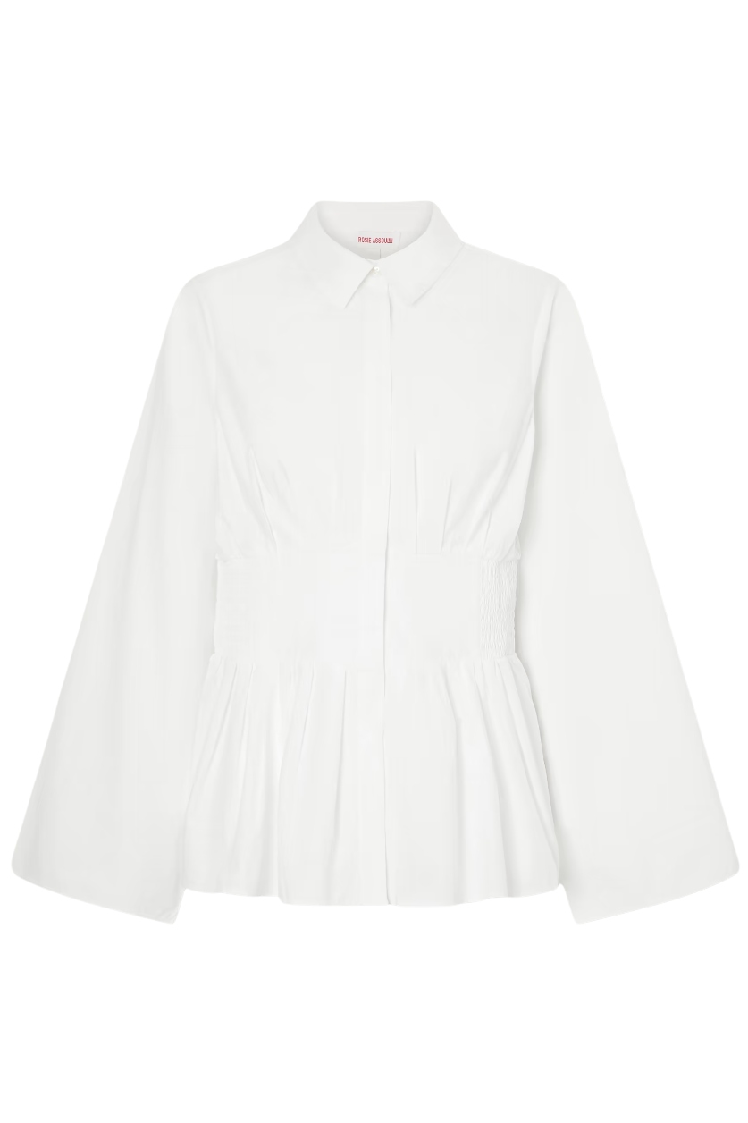 White long-sleeve shirred blouse with peplum waist.