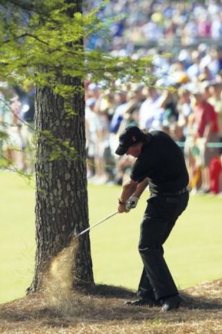 Phil Mickelson hitting from the pinestraw at the 2010 Masters