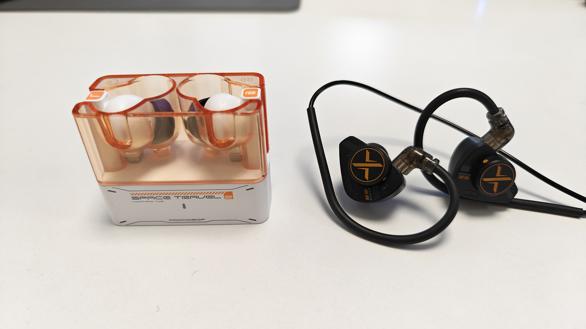 The OoopusX Op.22 earphones on a white desktop.
