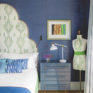 Blue bedroom with patterned scalloped headboard