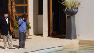 Two kids standing by the pool in Modern Family