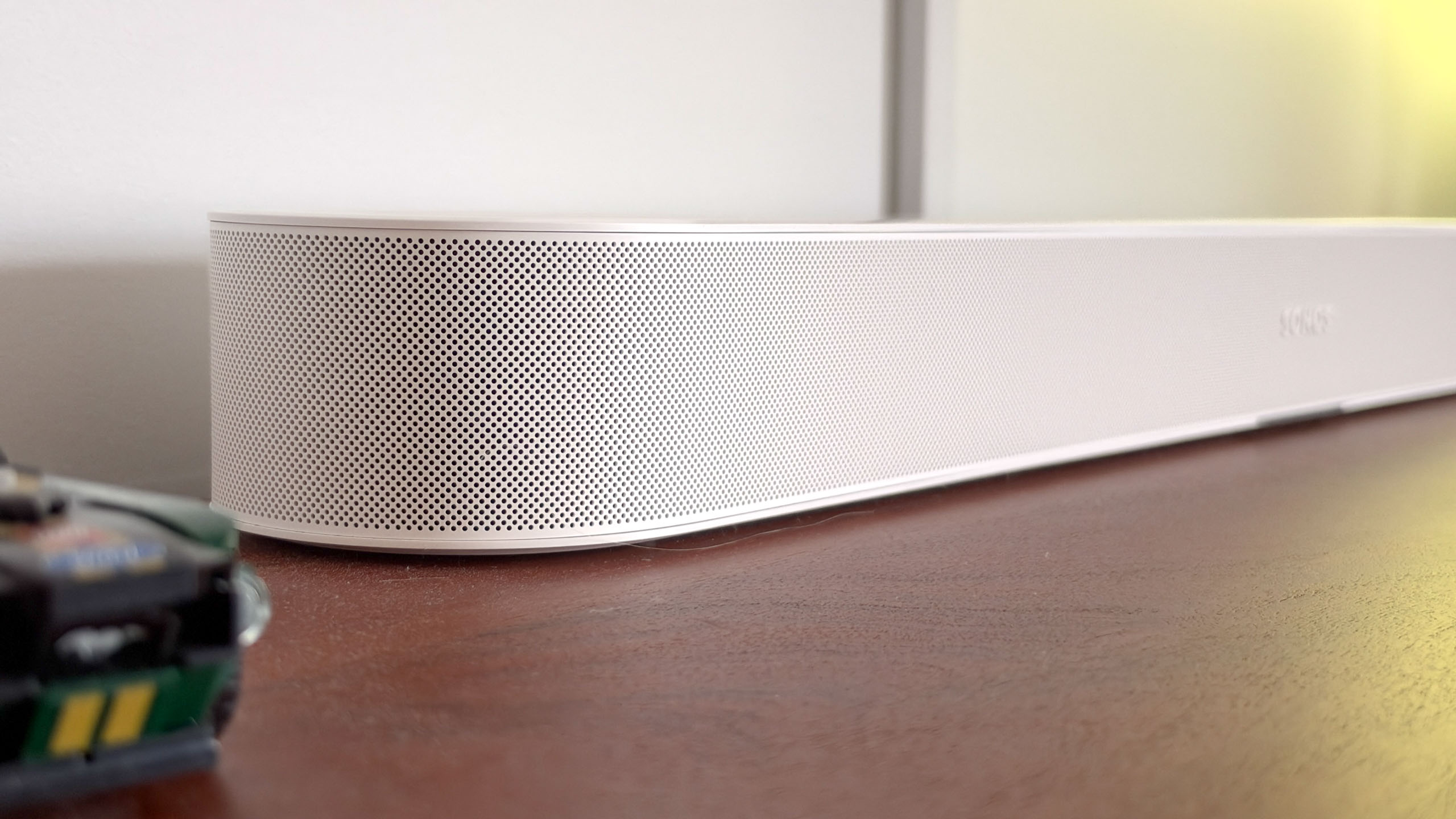 A Sonos Beam Ultra soundbar on a side table