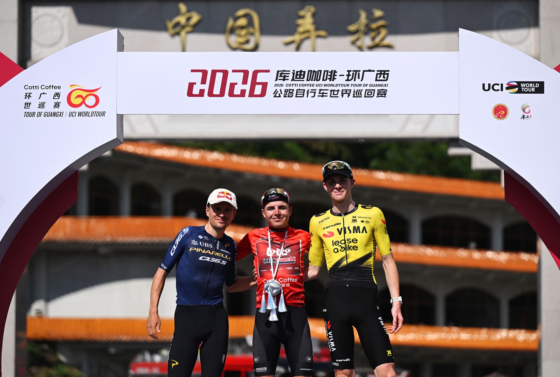 NONGLA, CHINA - OCTOBER 18: (L-R) Tom Pidcock of Great Britain and Pinarello Q36.5 Pro Cycling Team on second place, race winner Jarno Widar of Belgium and Team Lotto Intermarche - Red Leader Jersey and Louis Barre of France and Team Visma | Lease a Bike on third place pose on the podium ceremony after during the 7th Tour of Guangxi 2026, Stage 6 a 165.8km stage from Yizhou to NongLa 617m / #UCIWT / on October 18, 2026 in NongLa, China. (Photo by Dario Belingheri/Getty Images)