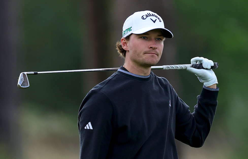 Rasmus Hojgaard with one hand off the club after an iron shot