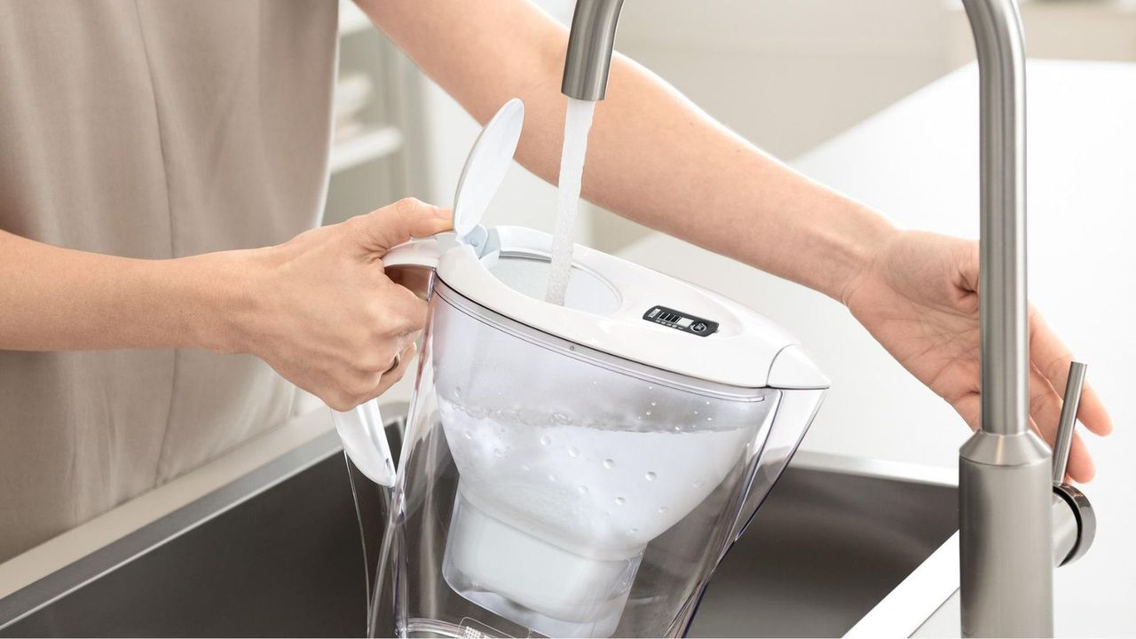 BRITA Water Filter Jug being filled under a silver tap