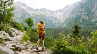 Happy female hiker enjoying the mountain landscape