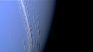Lines of clouds moving above Neptune's surface.