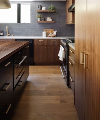 Wooden kitchen cabinets with gold, textured hardware