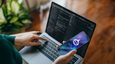 A stock image of a person using an AI chatbot and a laptop.