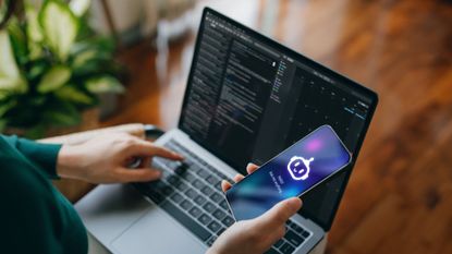 A stock image of a person using an AI chatbot and a laptop.