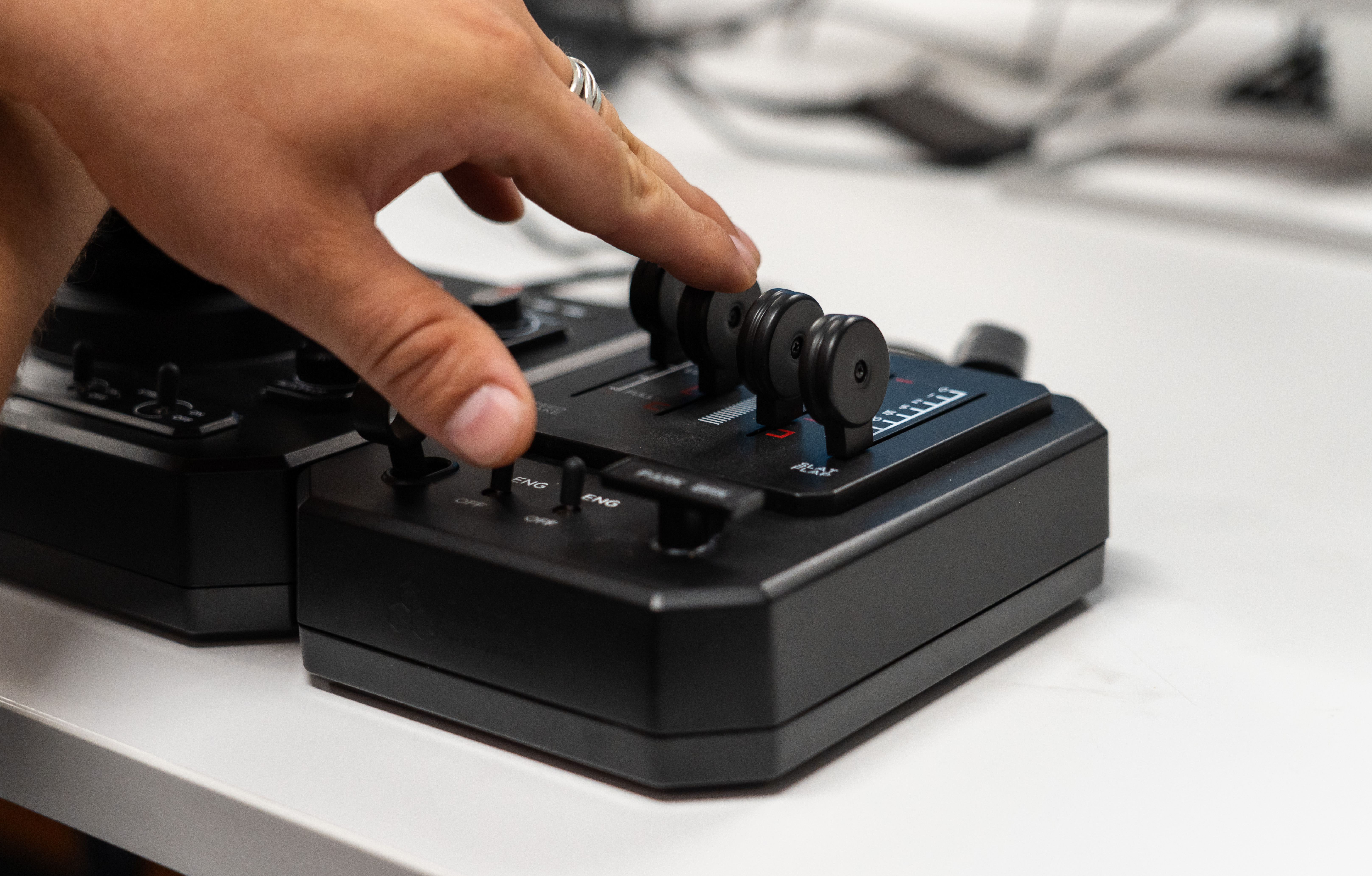 Honeycomb Aeronautical Foxtrot Aviation Stick attached to a throttle module prototype on a white desk.