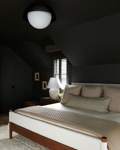 Dark black bedroom with white bed