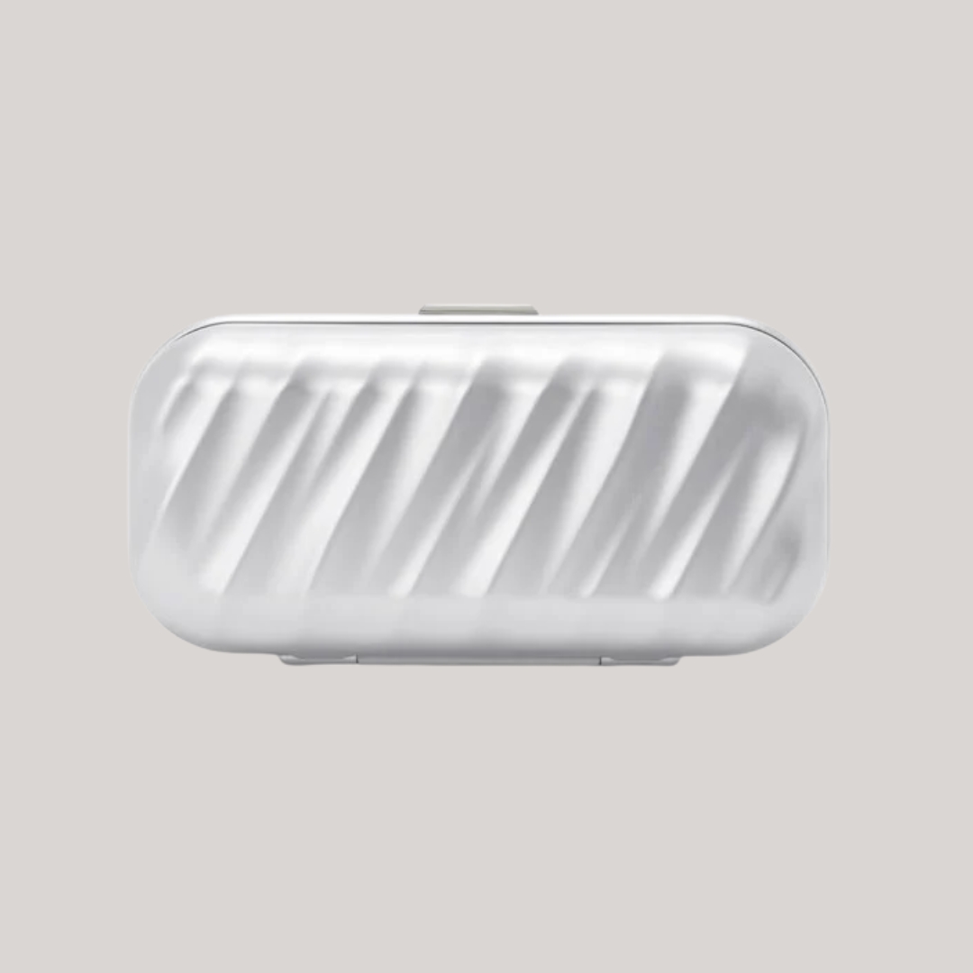 A silver-clad sunglasses case features a textural, wavy surface and pochette-like handy structure while sitting against a gray background.