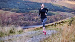 Woman running on hilly trail
