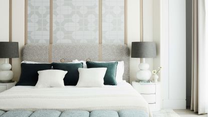 White bedroom with dark green throw cushions
