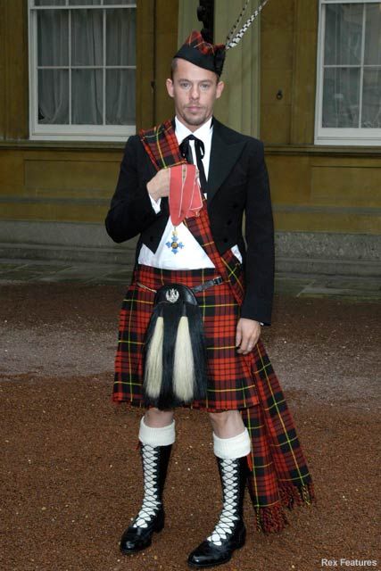 Alexander McQueen at Buckinham palace with his CBE Oct 2003