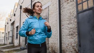 Woman doing running workout wearing jacket