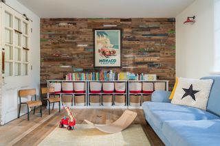 large playroom with reclaimed timber cladding on wall