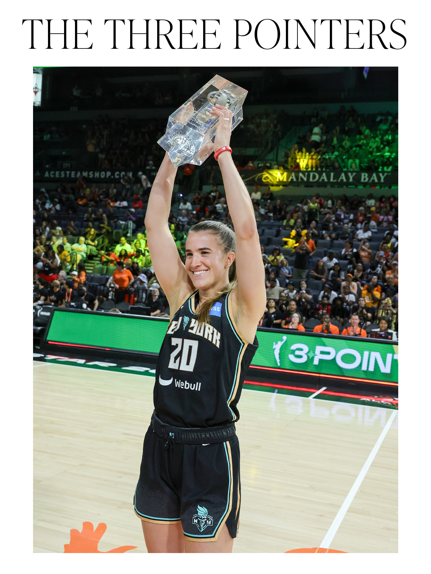 Sabrina Ionescu holding up her three-point contest trophy with the words "The Three Pointers" on top.