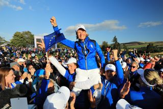 Catriona Matthew hoisted up by her team after winning the 2019 Solheim Cup