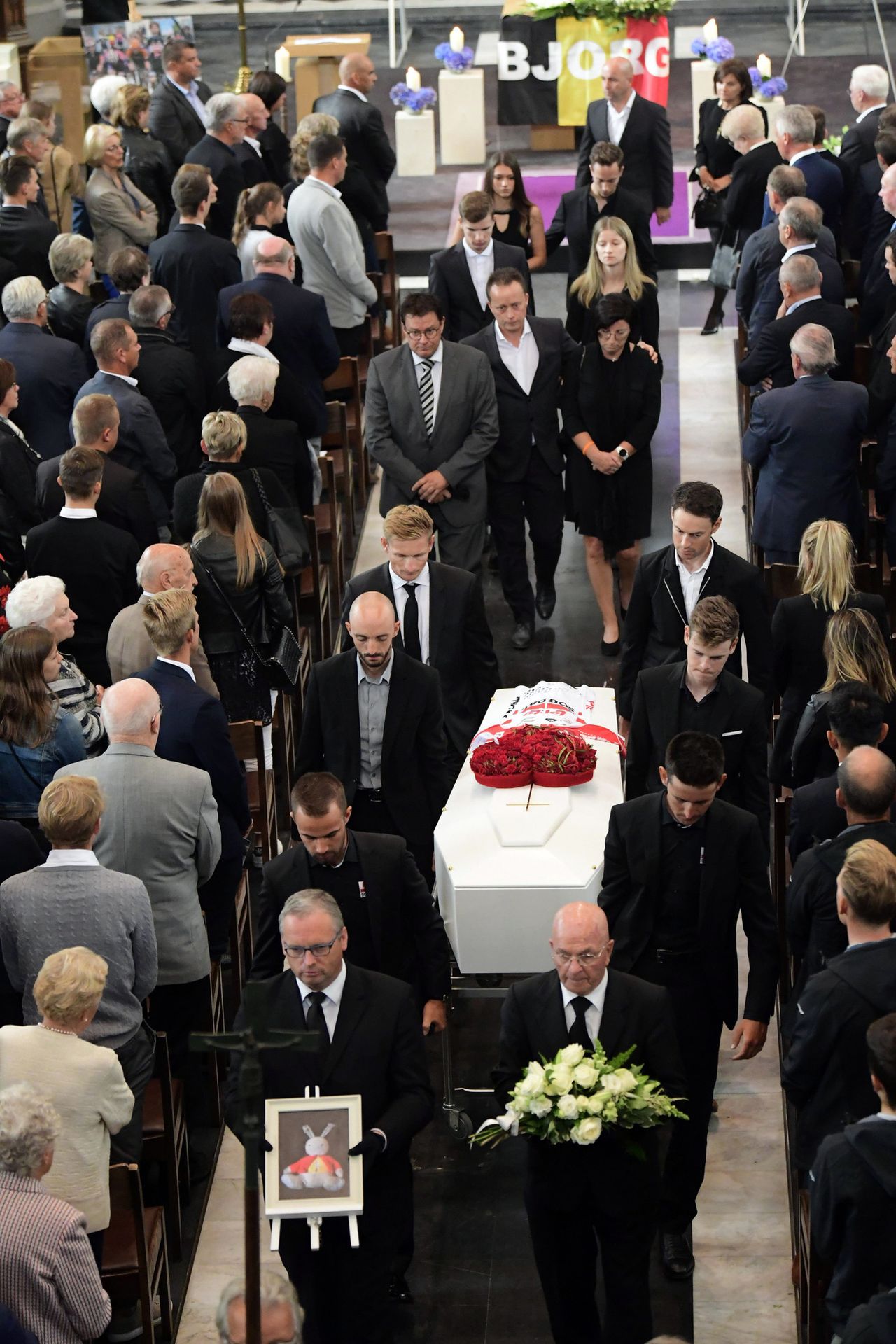 Teammates past and present were among Lambrecht's coffin bearers