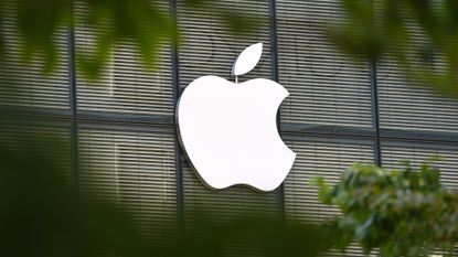 Apple logo pictured through a gap in foliage on the company's regional headquarters in Tokyo's Ginza district.