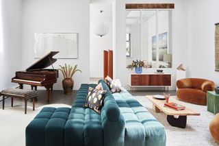A living room with white walls and colorful furniture
