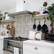 Gas stove in white themed kitchen