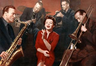 judy garland in. ared dresss singing around a bunch of horn players in A star is born