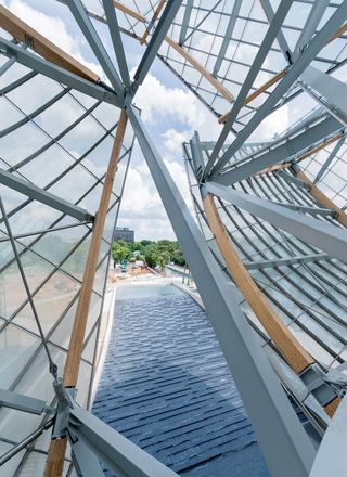 The new Louis Vuitton Foundation in Paris. A view of the building's twelve curving glass 'sails' which are supported by wooden beams.