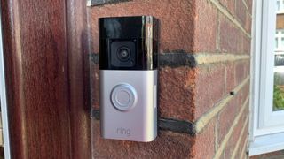 Ring Battery Doorbell Plus mounted on a brick wall