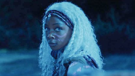 Zelie (Mbedu) , a woman with the power to command undead spirits in her homeland, the kingdom of Orisha, Children of Blood and Bone (2027).