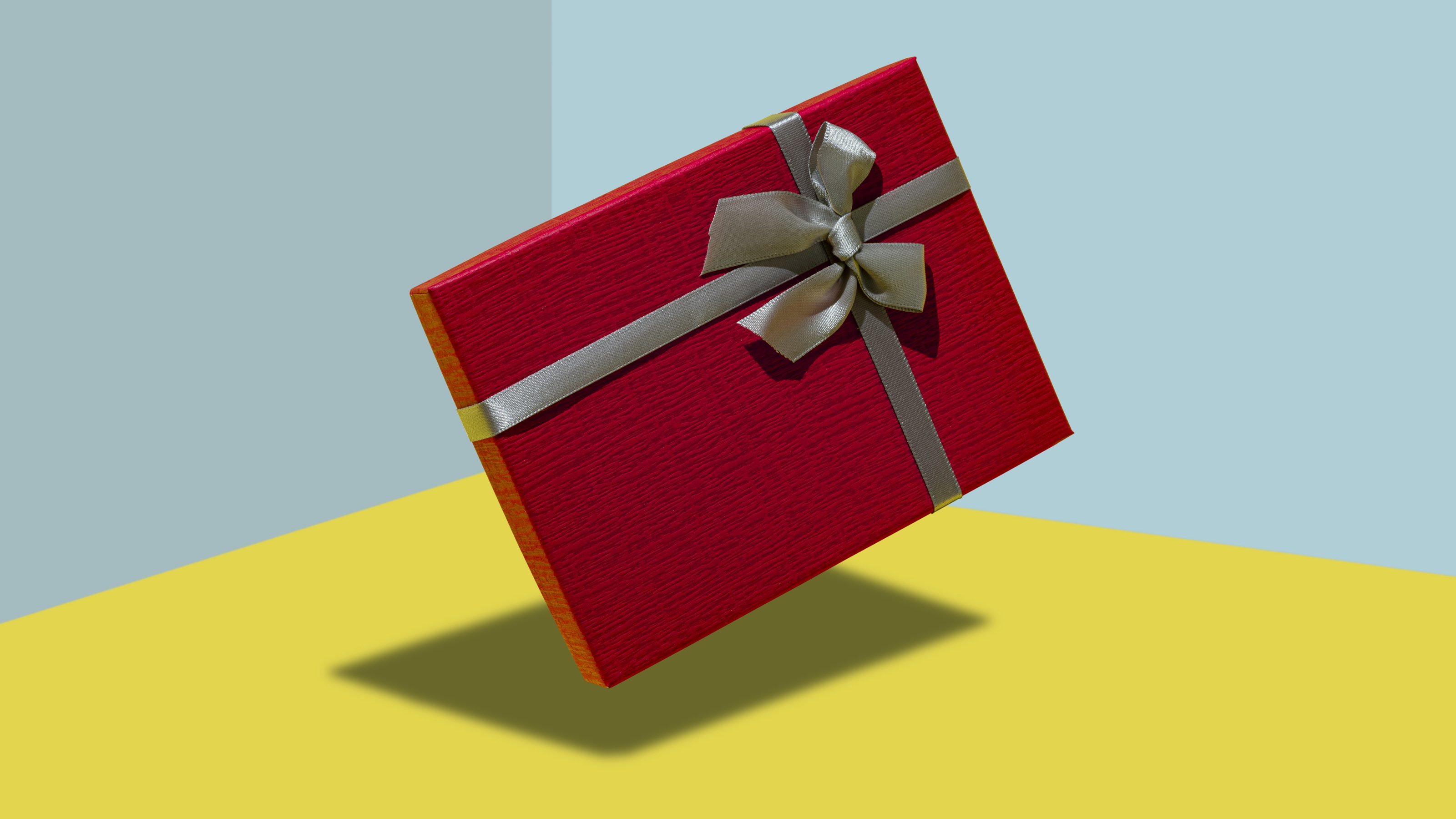 A gift wrapped in red with a silver bow.