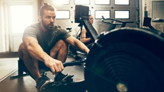 Do rowing machines build muscle: image shows man using a rowing machine