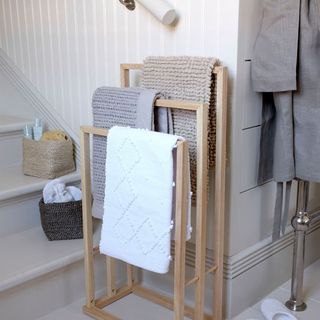neutral bathroom with metal radiator and soft furnishings