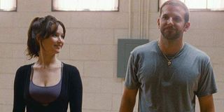Jennifer Lawrence and Bradley Cooper smile during dance practice in Silver Linings Playbook.
