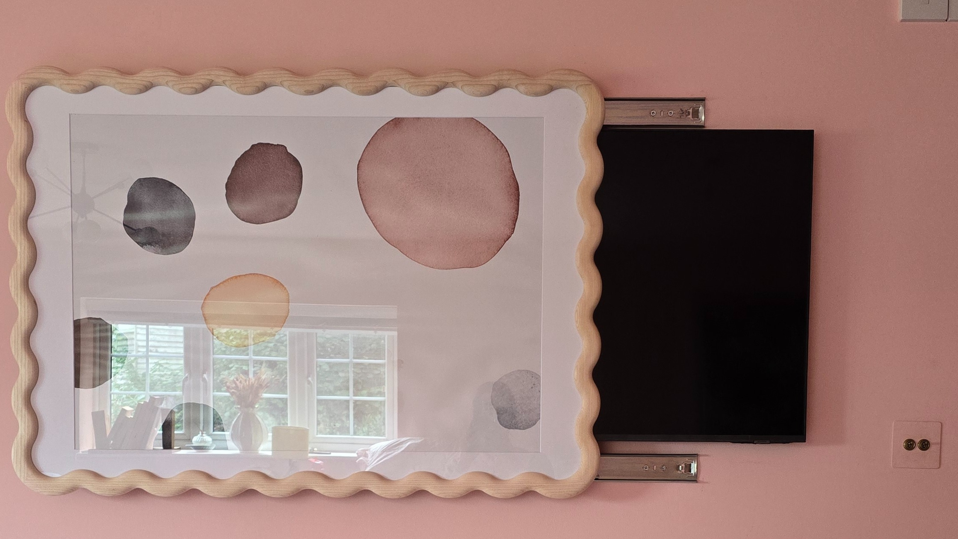 The completed frame hack showing the Habitat wav frame covering half a wall-mounted tv.