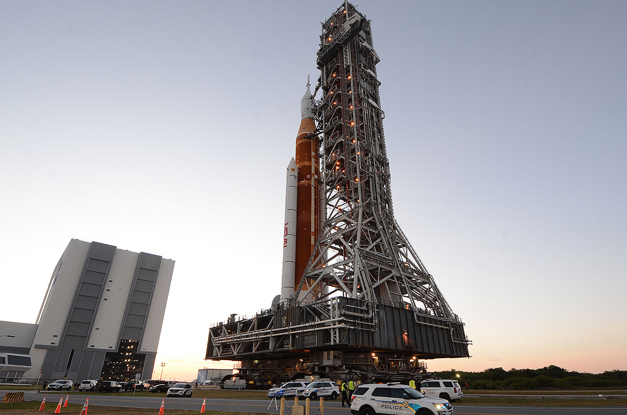 NASA's Artemis I Space Launch System (SLS) is moved for the first time to the launchpad after departing the Vehicle Assembly Building (VAB, at left) at the Kennedy Space Center in Florida on Thursday, March 17, 2022.