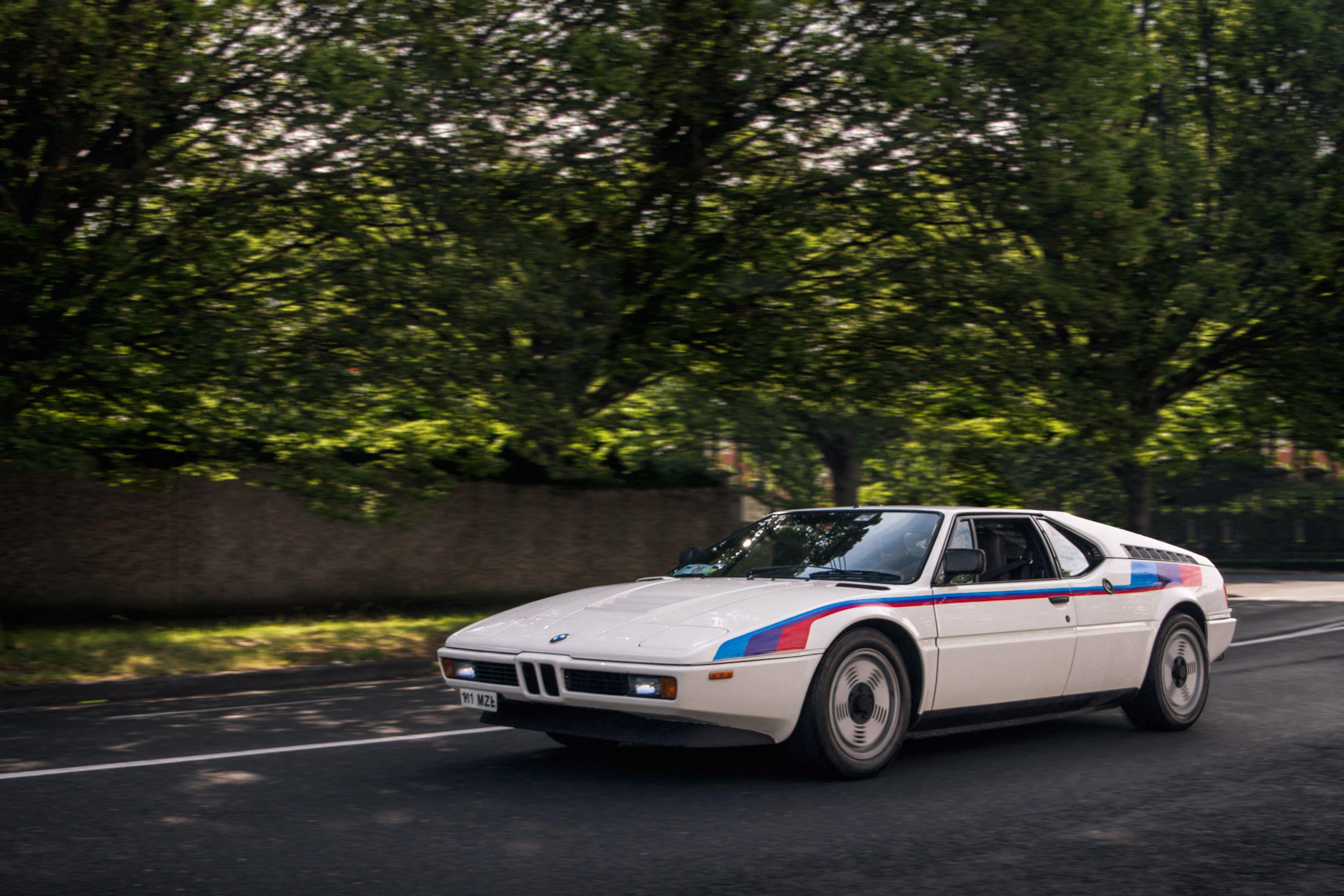 White BMW M1 classic supercar driven on a road in central Dublin, Ireland.