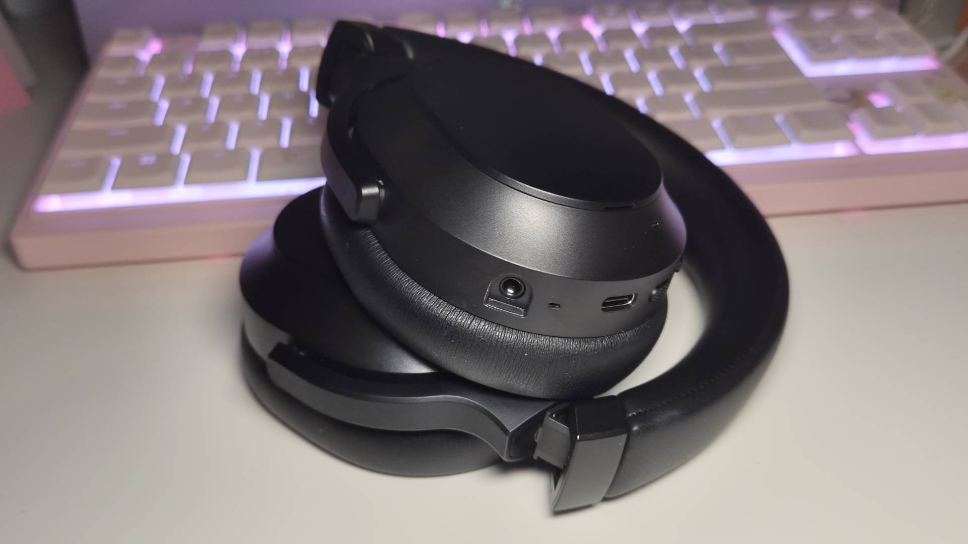 Photo of the folded up Razer Barracuda V2 Pro headset on a white gaming desk.