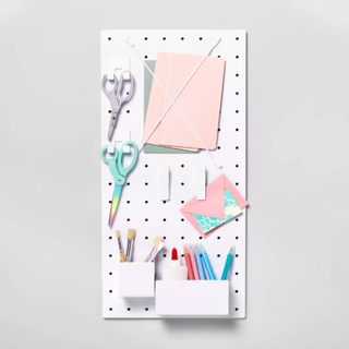 White pegboard with craft supplies attached
