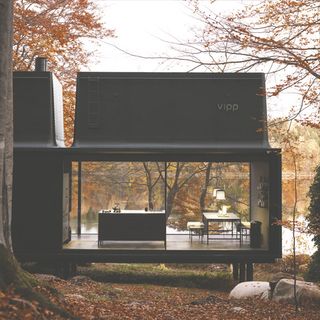 vipp shelter in forest sleek exterior and river